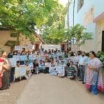 Group of students and faculty members participating in a mental health awareness rally at Patna University Psychology Department, holding placards promoting mental health.